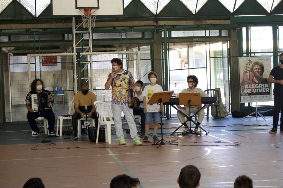 Os músicos no centro da quadra: sanfona, violino, teclado e o banner do disco.